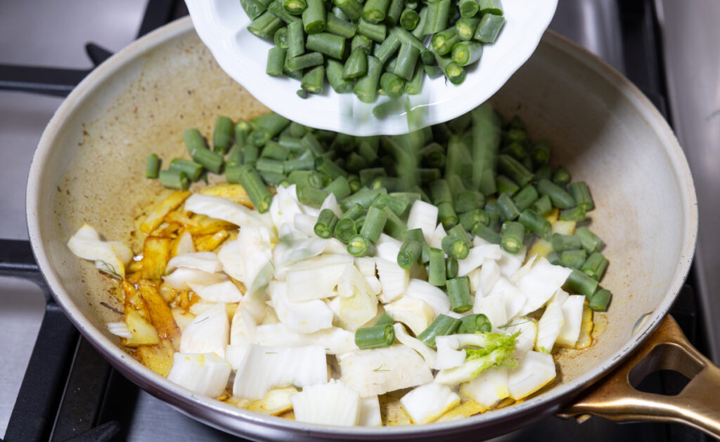 green beans and fennel bulb in skillet